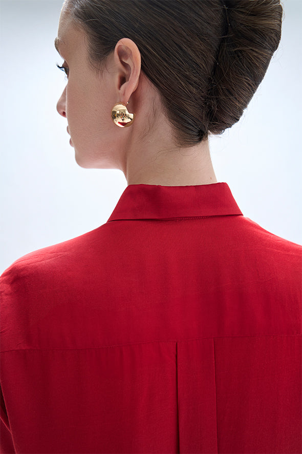 Full-sleeve red modal satin shirt featuring a high-low hem with an apple cut from Aroka.