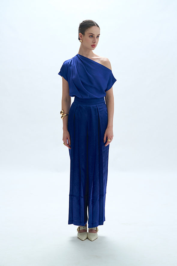 Off-shoulder cowl drape with pleated pants in blue from Aroka.