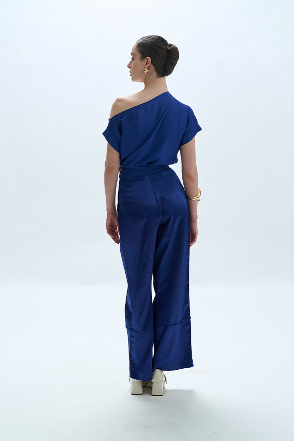 Off-shoulder cowl drape with pleated pants in blue from Aroka.