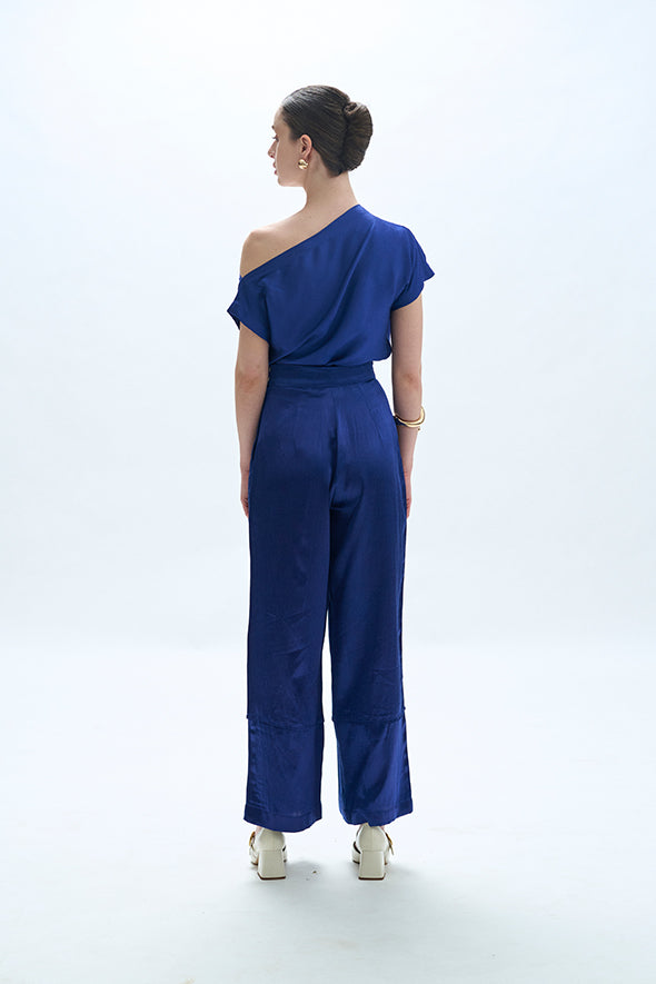 Off-shoulder cowl drape with pleated pants in blue from Aroka.