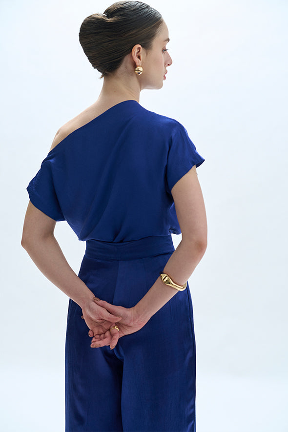 Off-shoulder cowl drape with pleated pants in blue from Aroka.