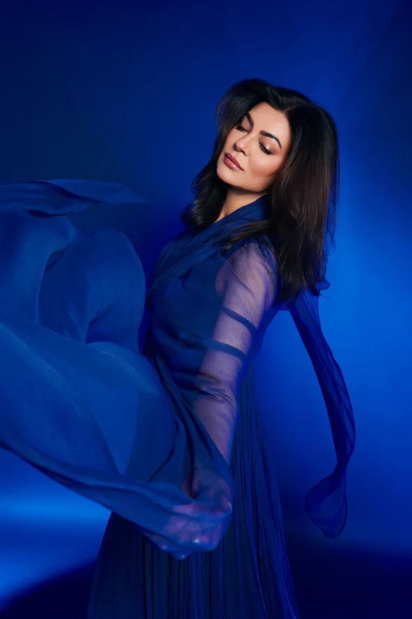 Maya Dress by Aroka, worn by Sushmita Sen for launch party. A layered vegan chiffon dress, thigh-high slit, and sheer floor-grazing sleeves for every evening occasion.