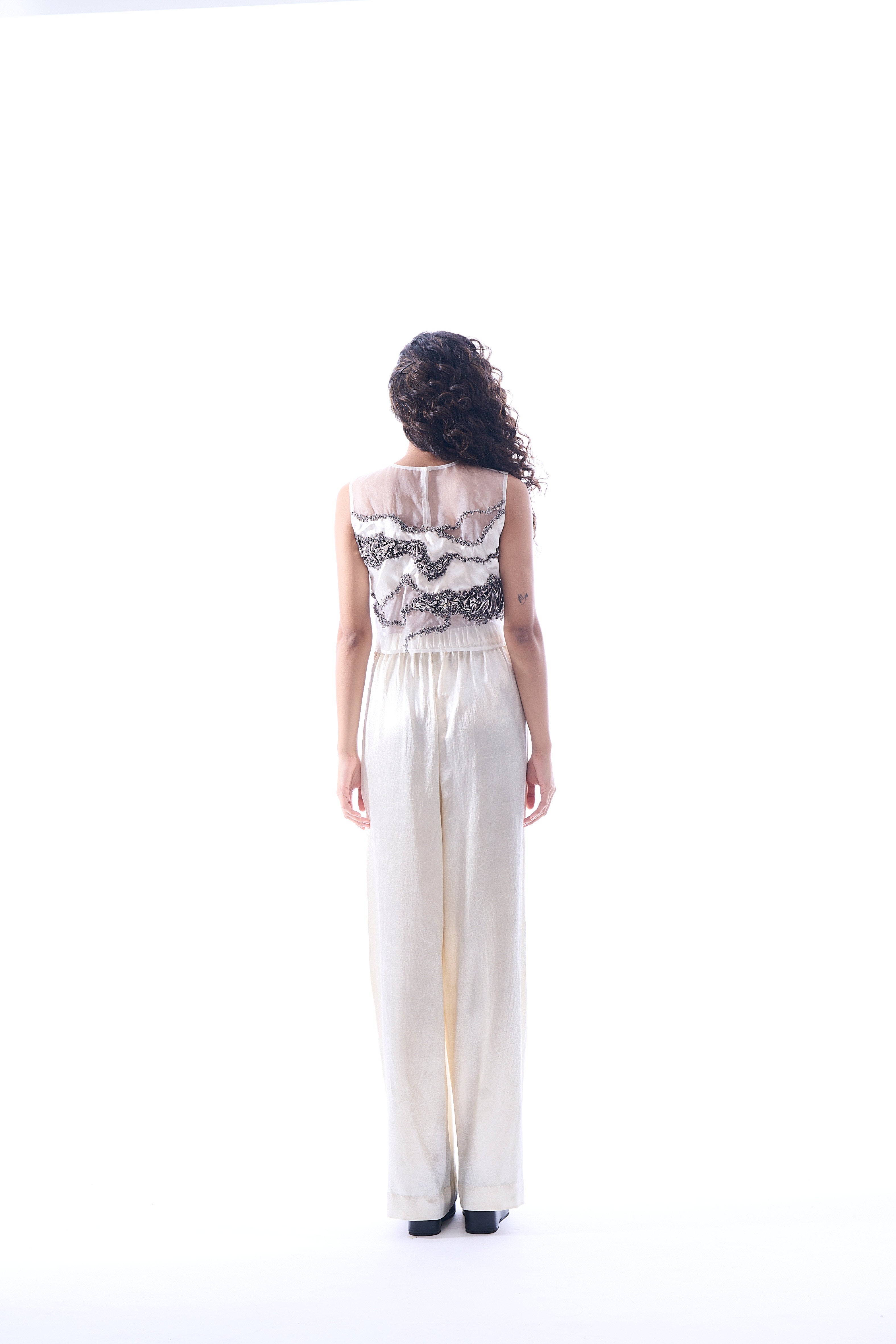 White pants made in mashru featuring wide-legged fit with side zipper from Aroka.