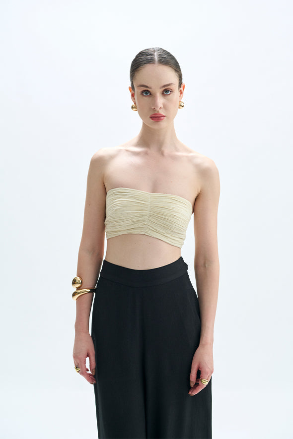 Off-white muslin ruched bandeau top with Moroccan crepe, straight fit with welt pockets Pants in black from Aroka.