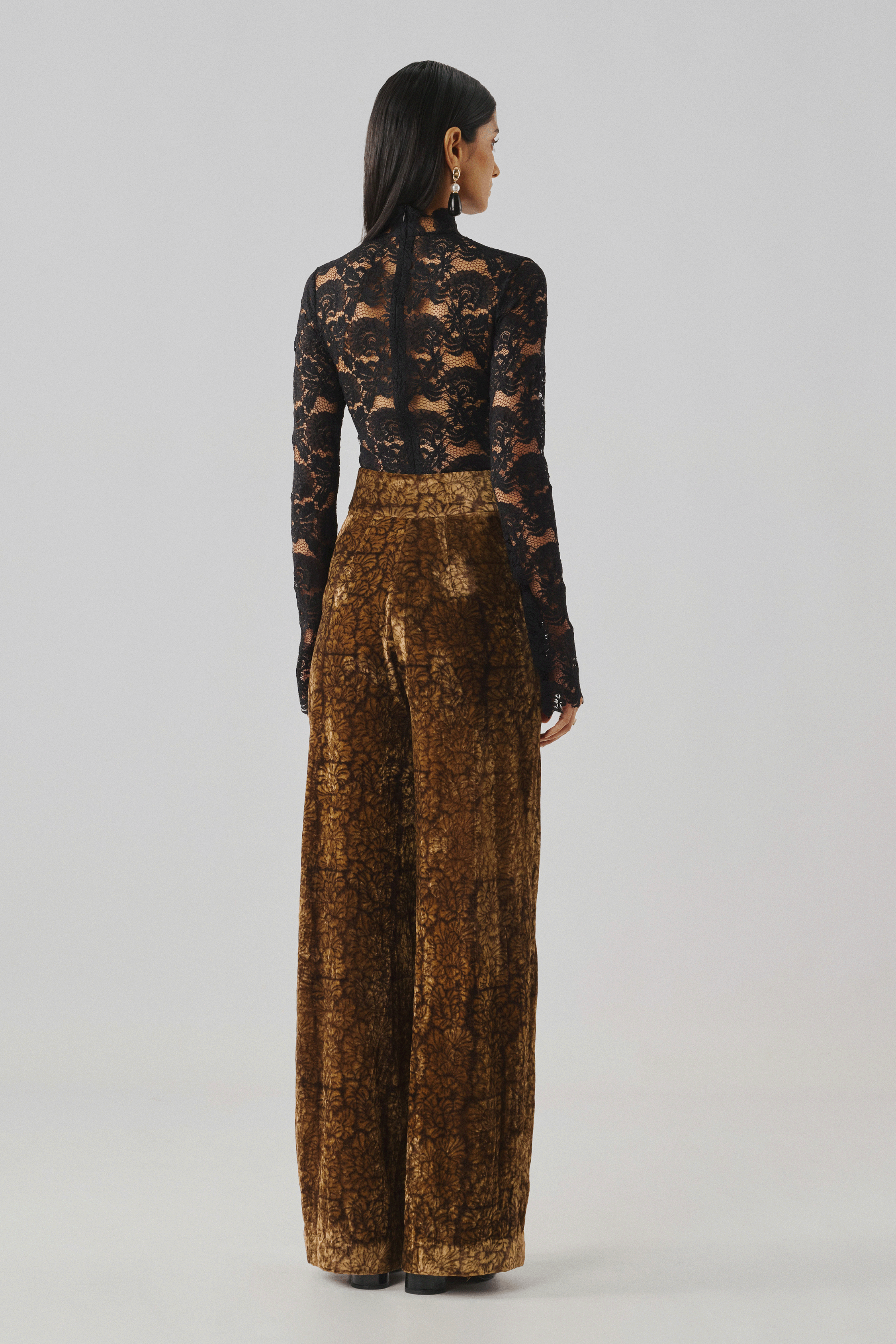 Black floral lace long-sleeve top with wide-leg trousers, rear view