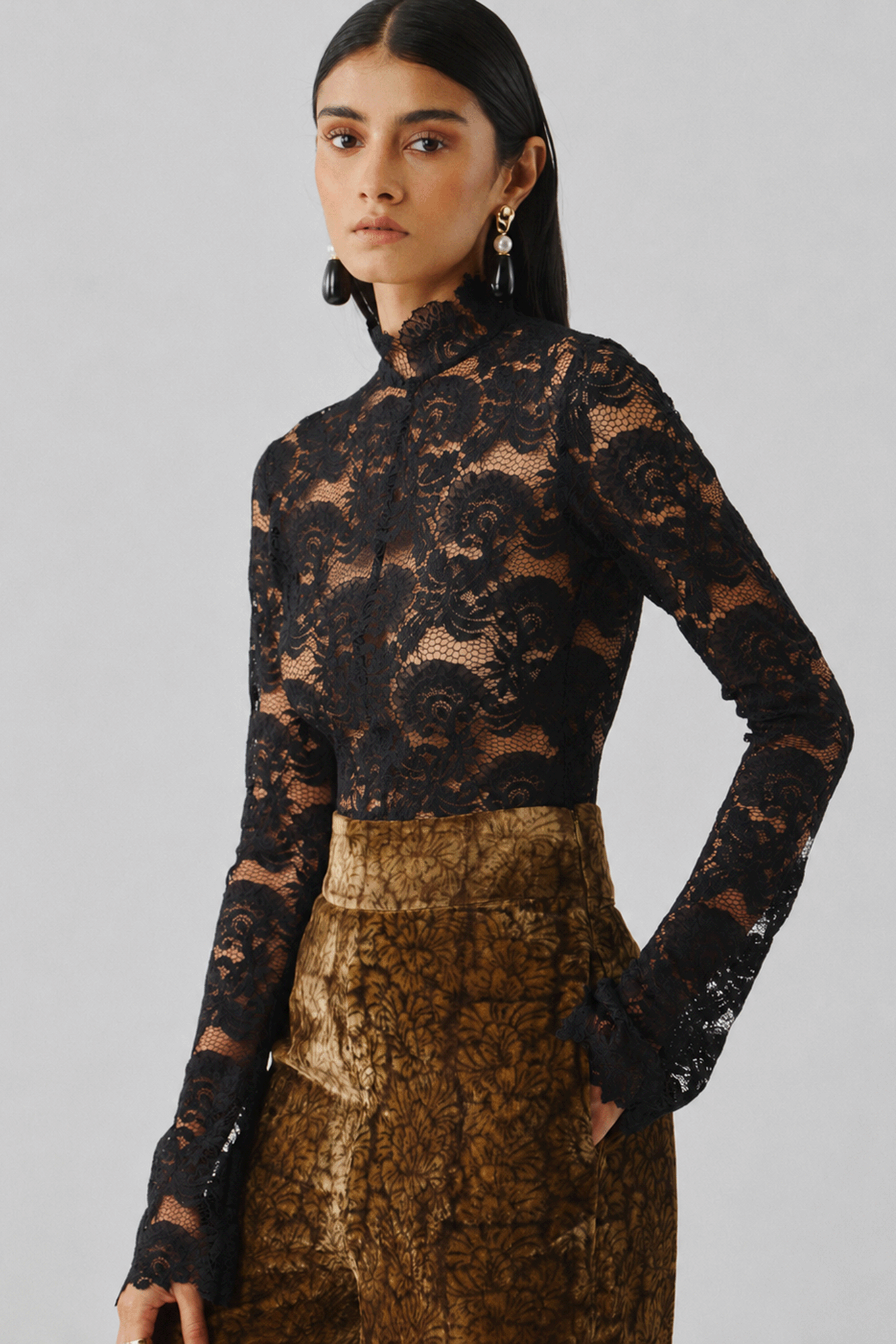 Black lace top styled with a bronze printed skirt, front view