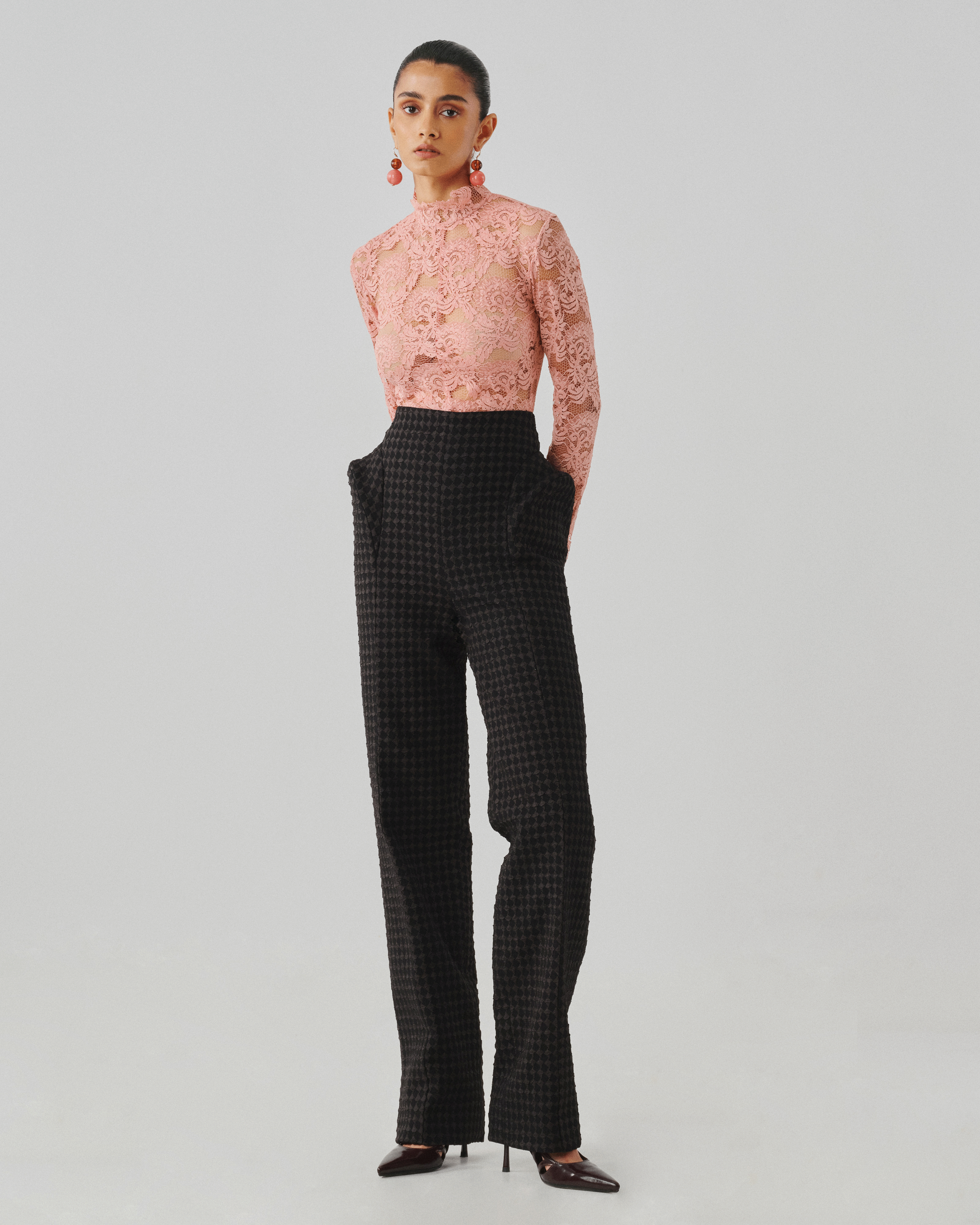 Blush pink lace top with black tailored trousers, front full view