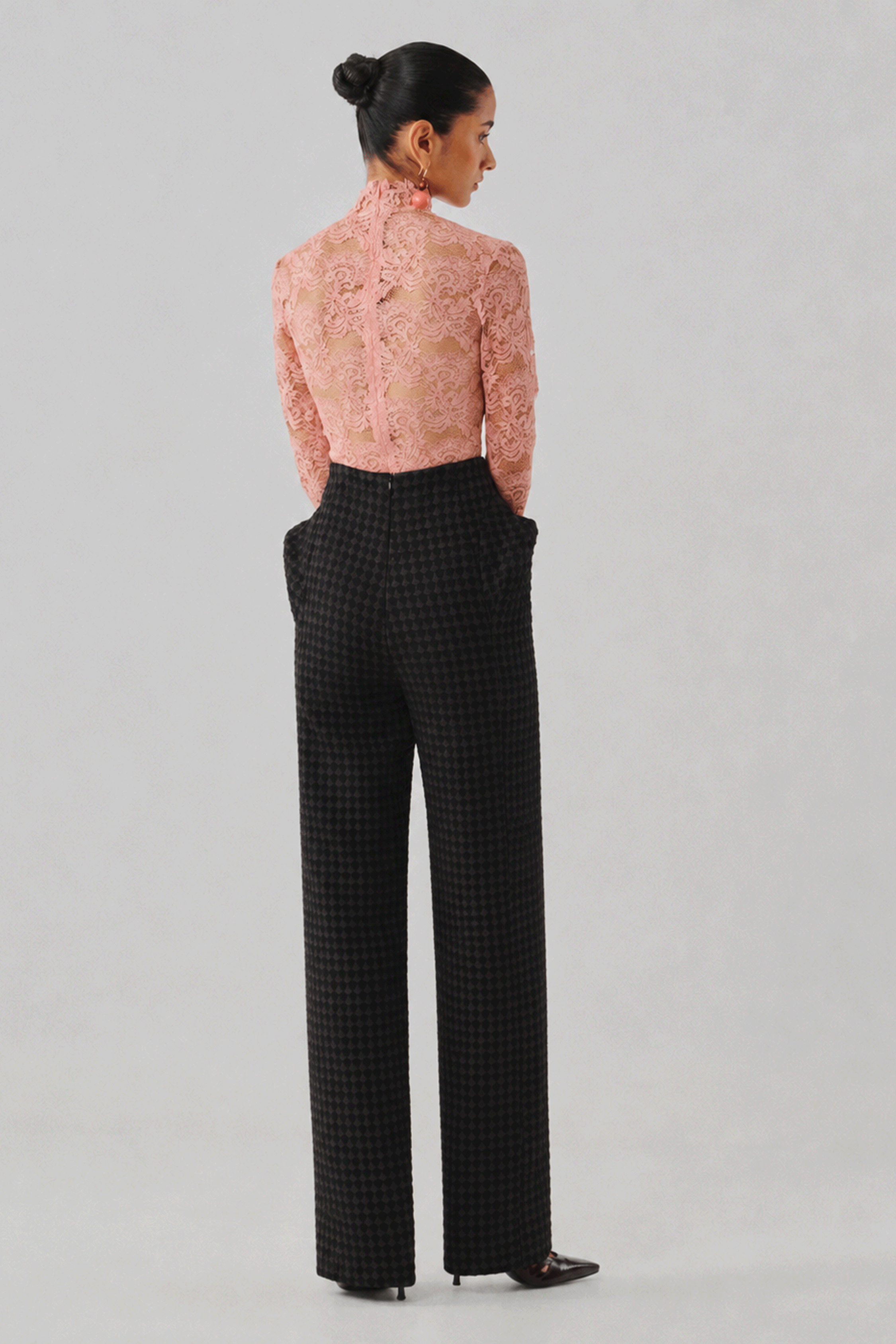 Black tailored wide-leg trousers, close-up front detail view