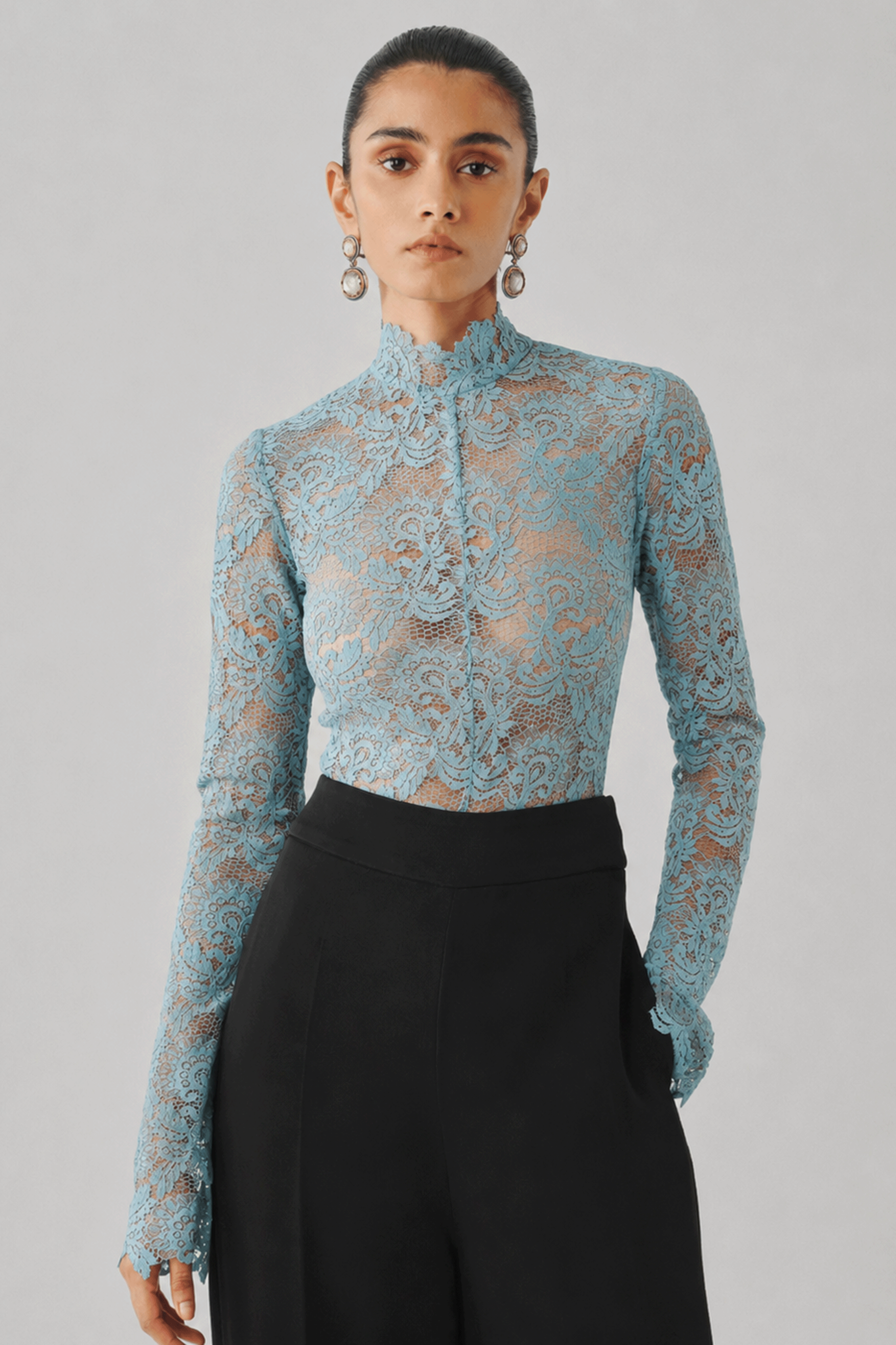 Sky blue lace top paired with a black skirt, front close-up view