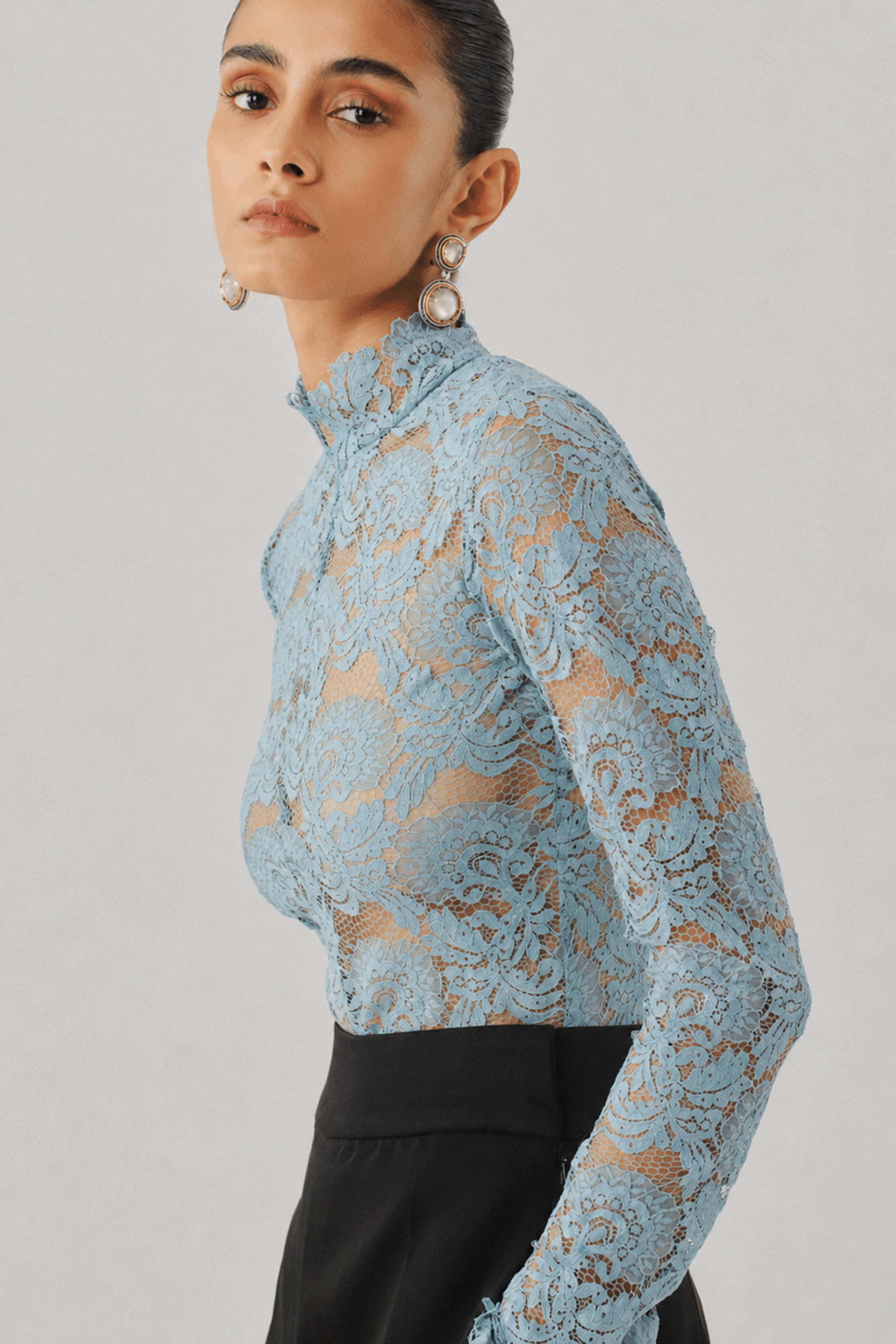 Sky blue lace top with a high neckline, close-up front view