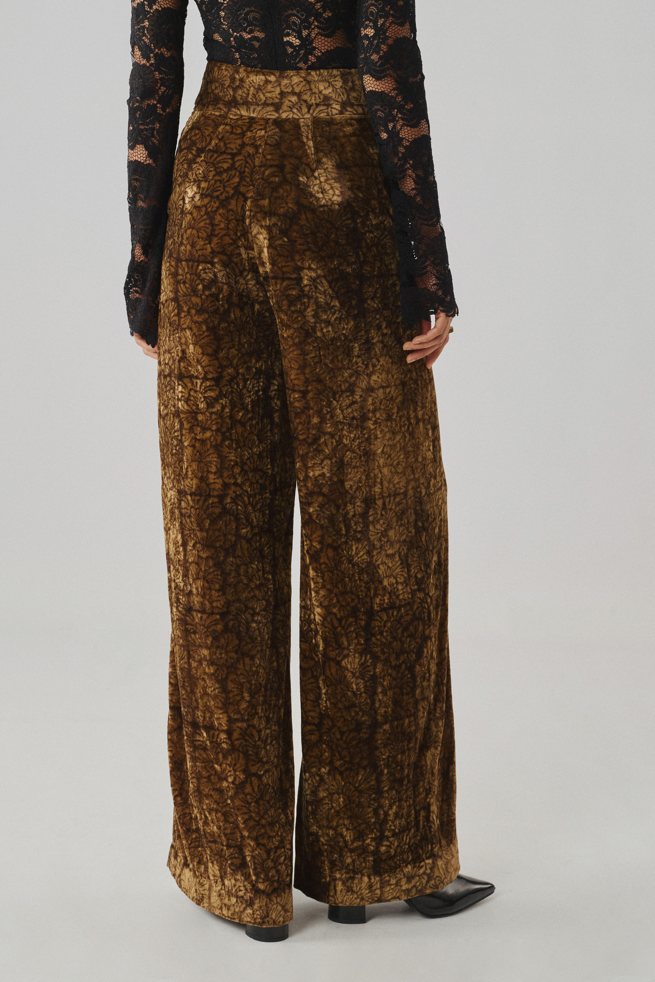 Bronze Ajrakh-print wide-leg trousers styled with a fitted top, front