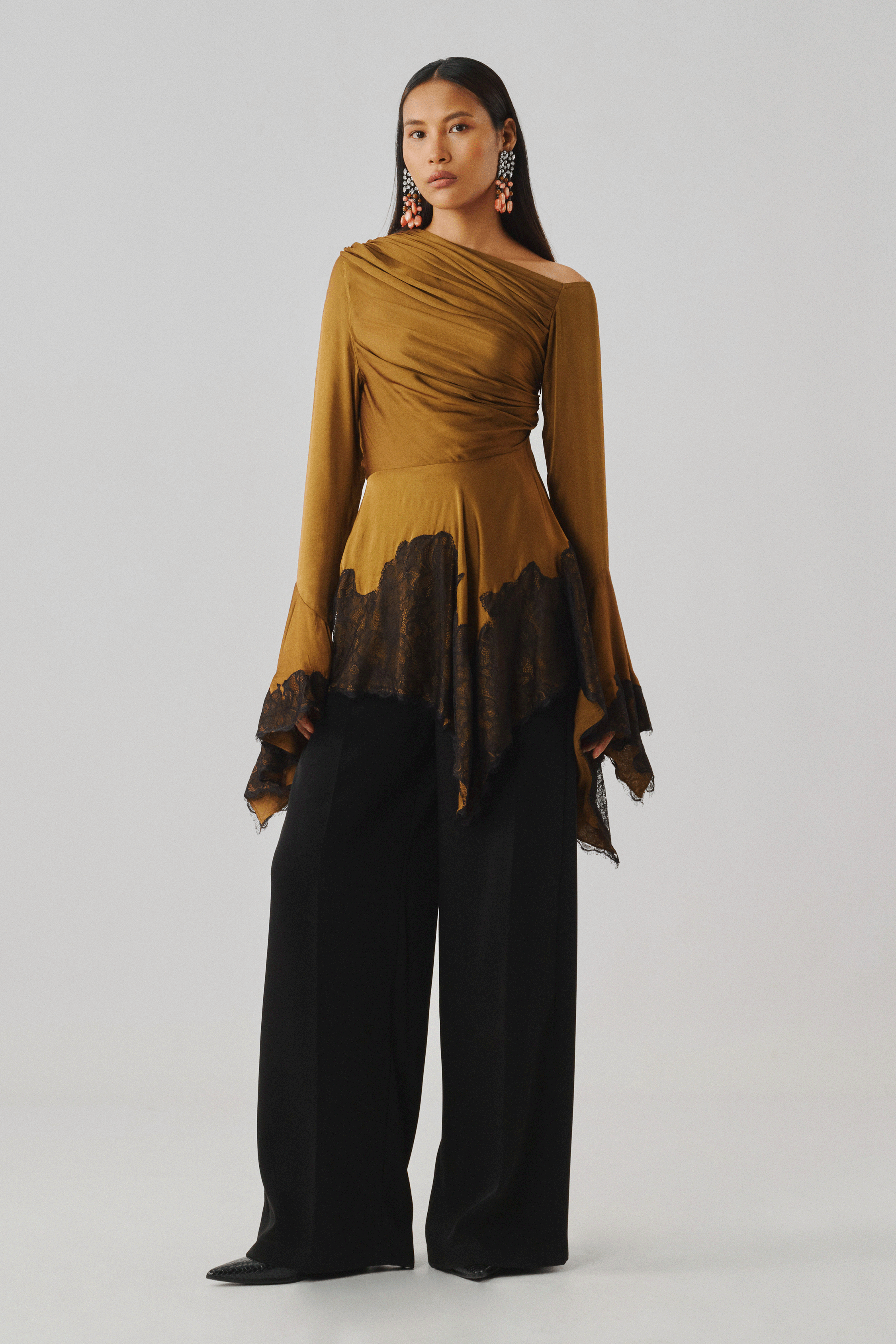 Bronze draped top with a dramatic sleeve, close-up front view
