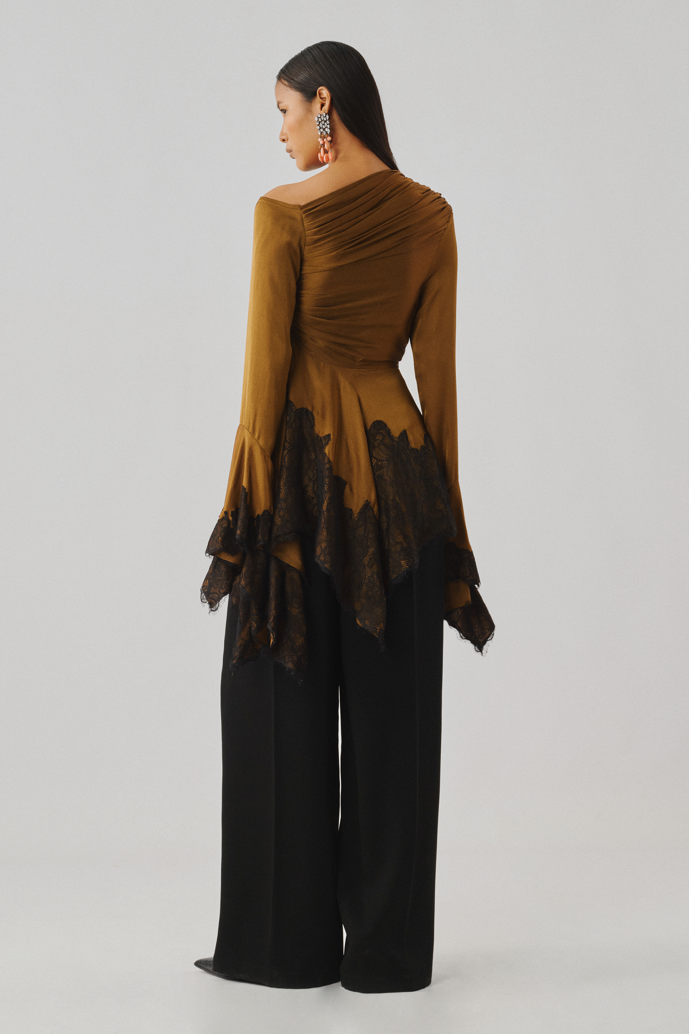 Bronze draped top with an asymmetric sleeve, full-length front view