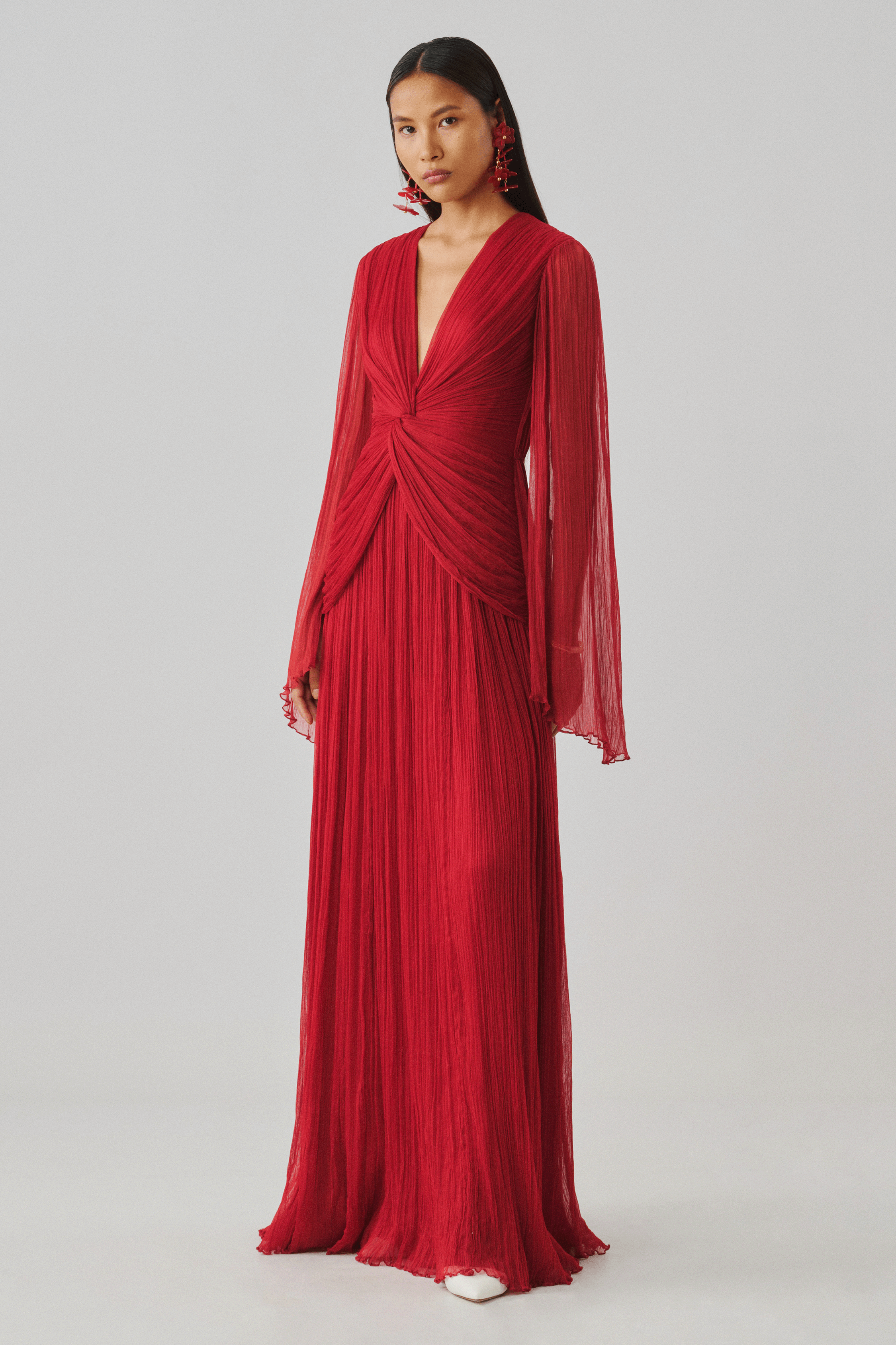 Red pleated gown with a draped wrap bodice, rear full-length view