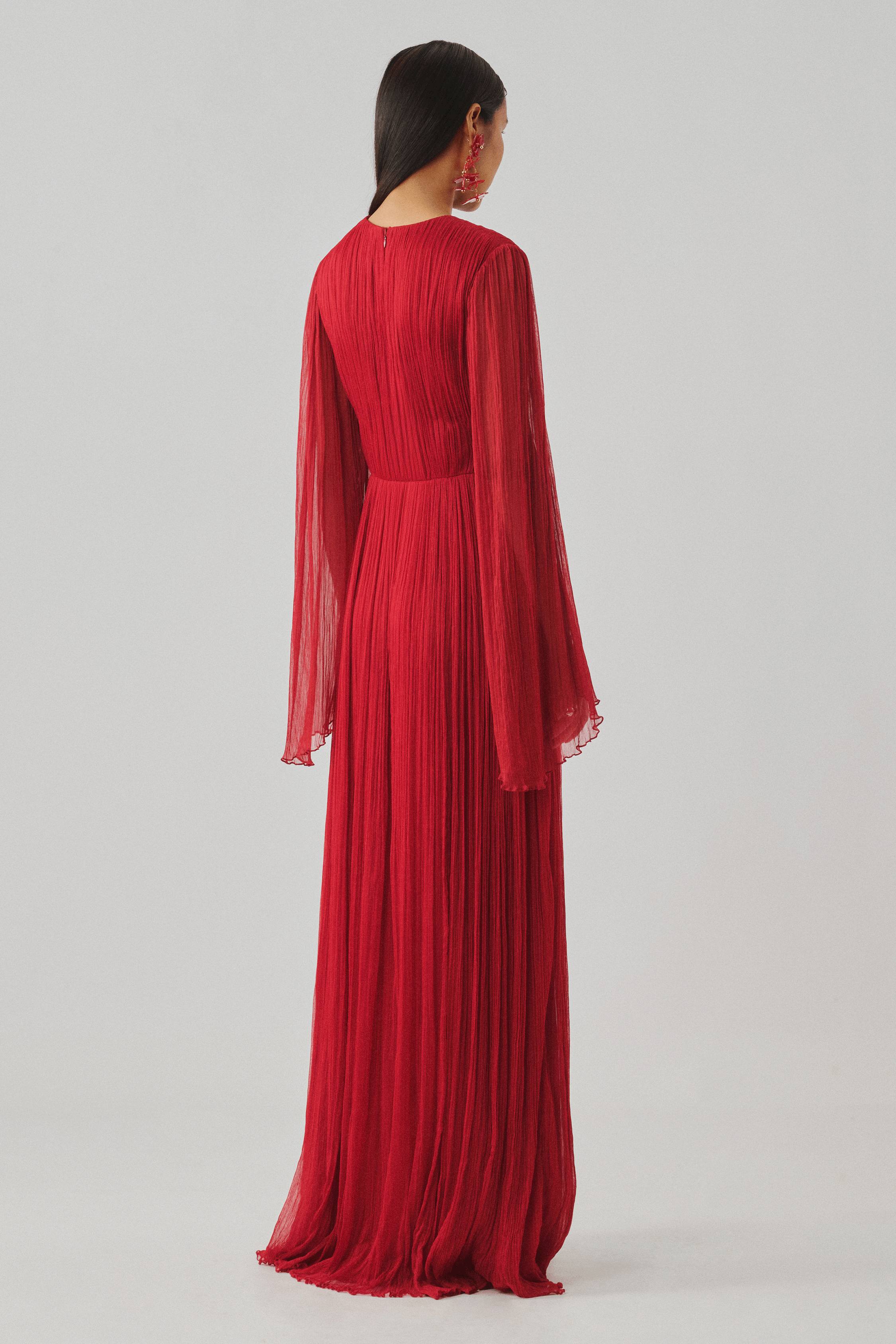 Red pleated long-sleeve gown with cascading sleeves, front view