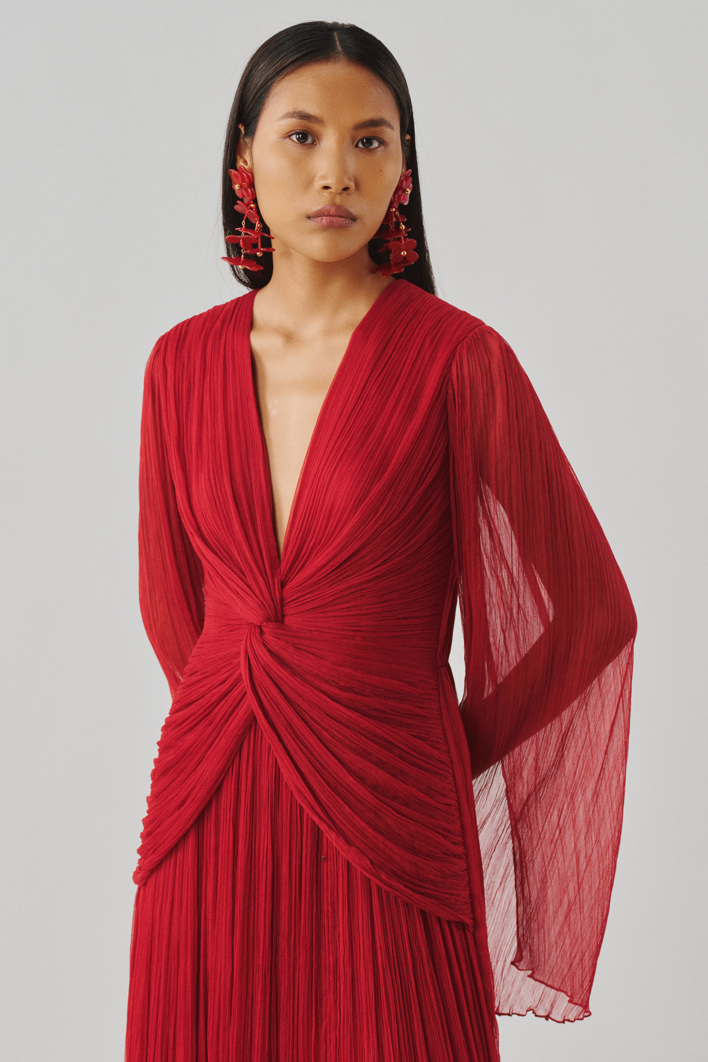 Red pleated gown with a fitted draped bodice, front full view