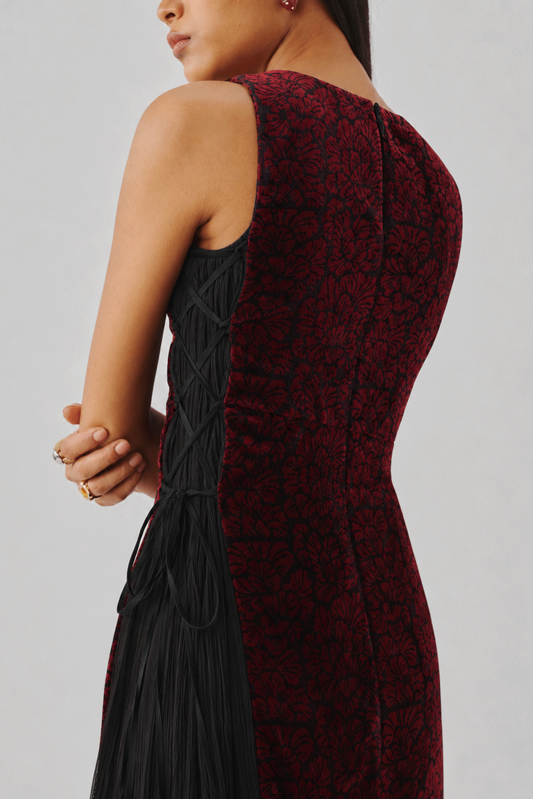 Burgundy velvet gown with a fitted bodice, close-up side view