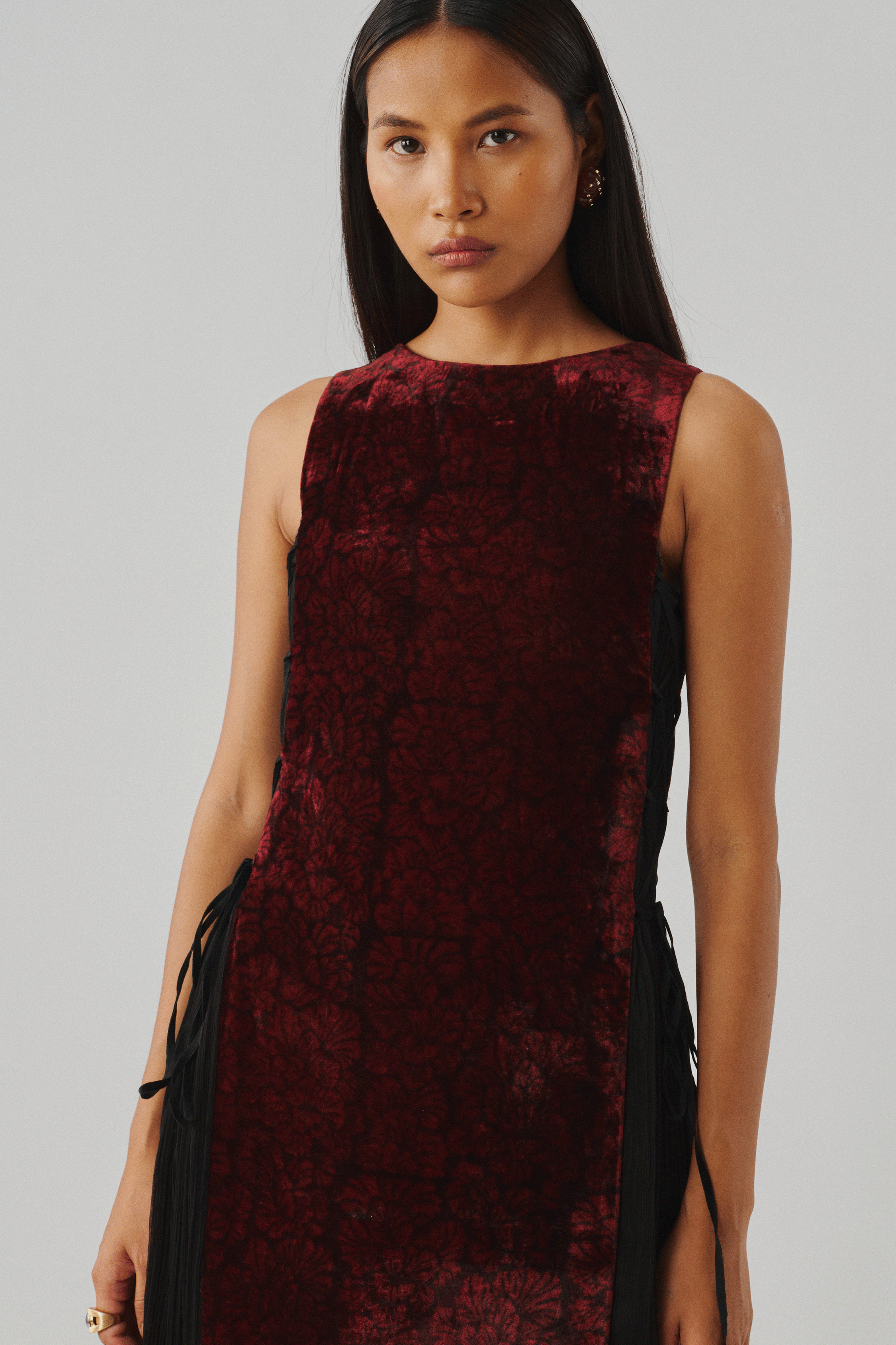 Burgundy velvet sleeveless dress, close-up front detail view