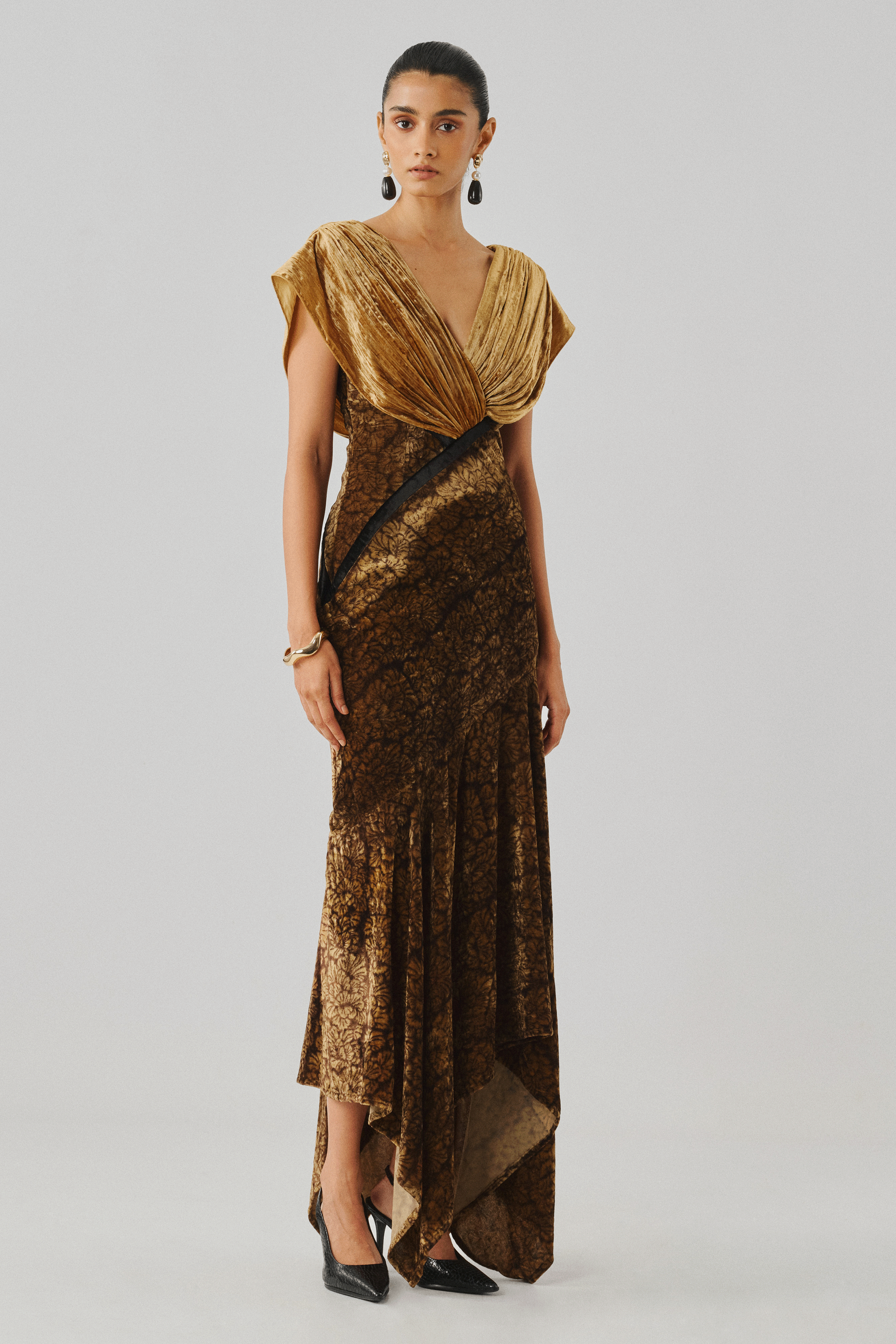 Gold velvet draped gown with a fitted bodice, rear profile view