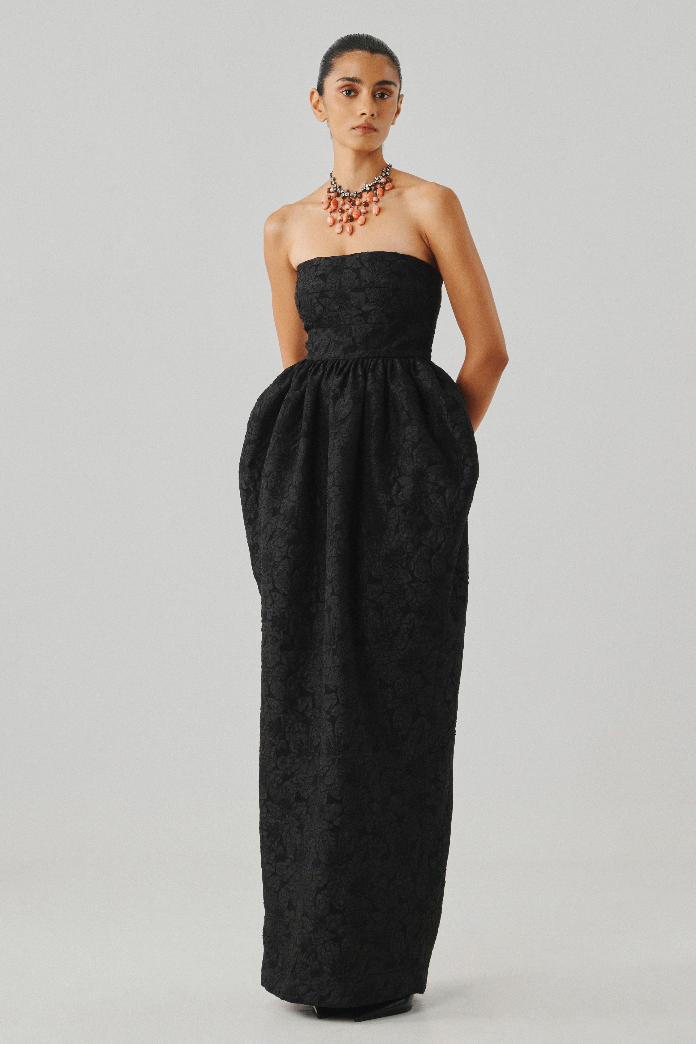 Black strapless gown with a full skirt, front full-length view
