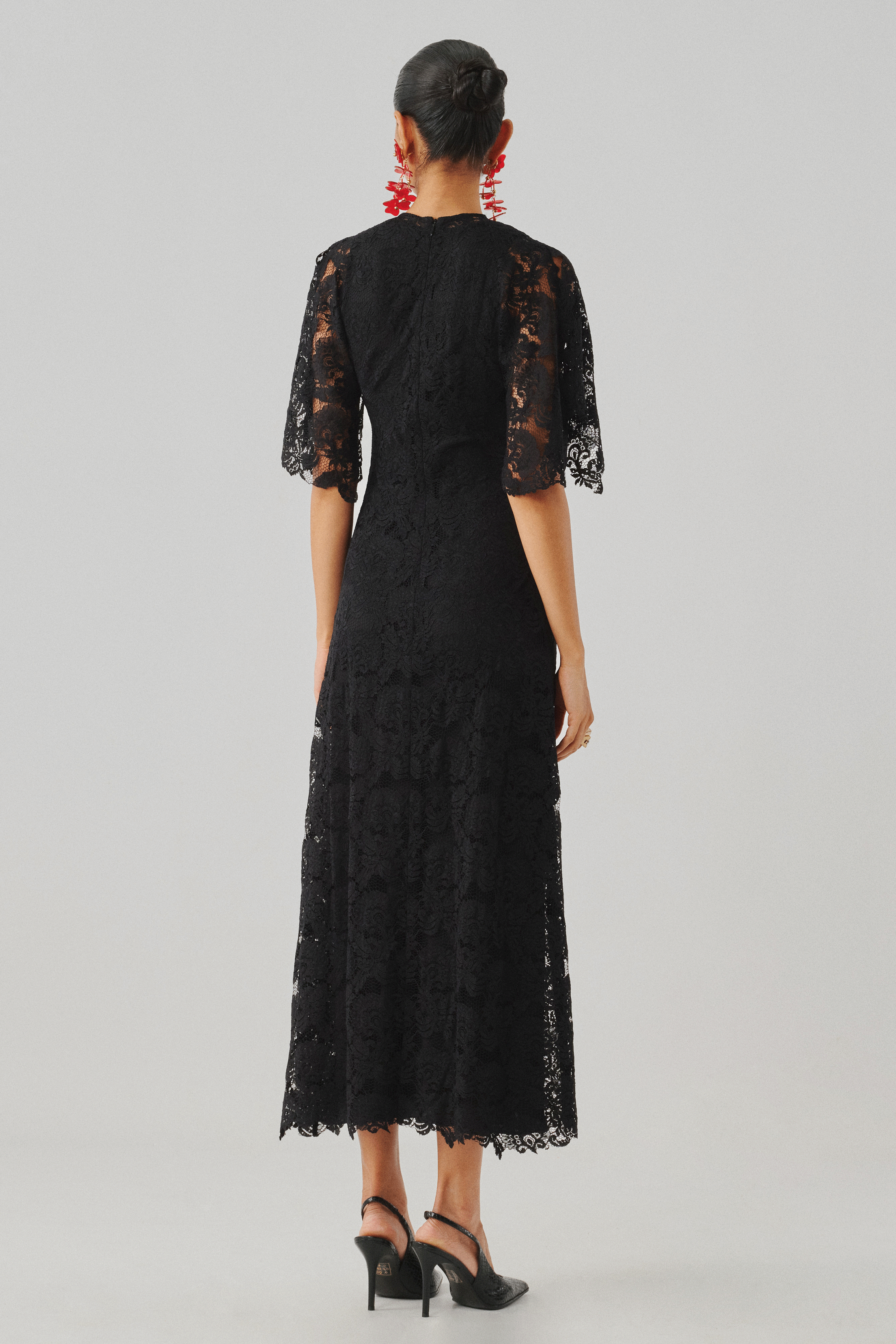 Black lace long-sleeve dress with a fitted silhouette, rear view
