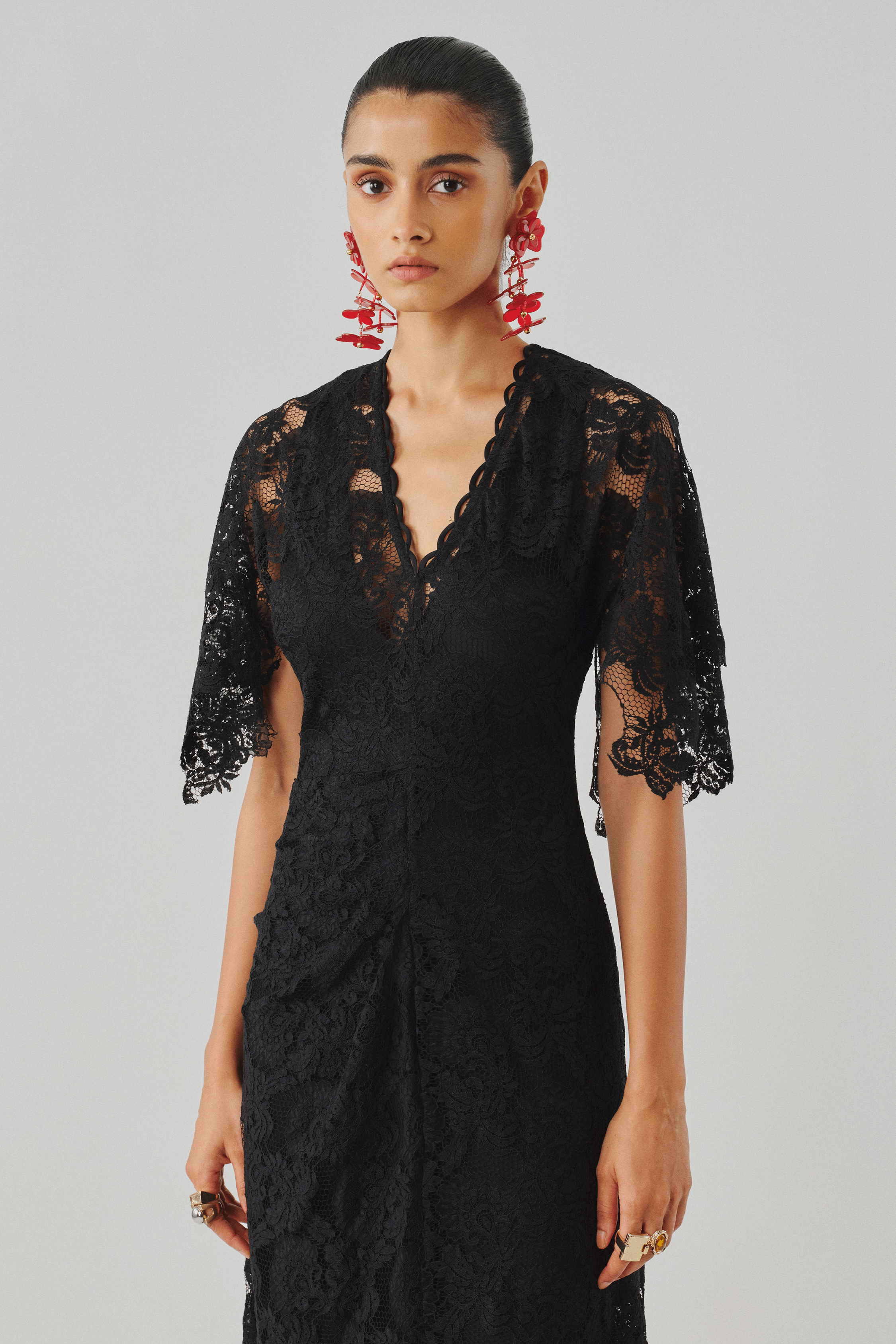 Black lace top with a draped wrap skirt, front full-length view