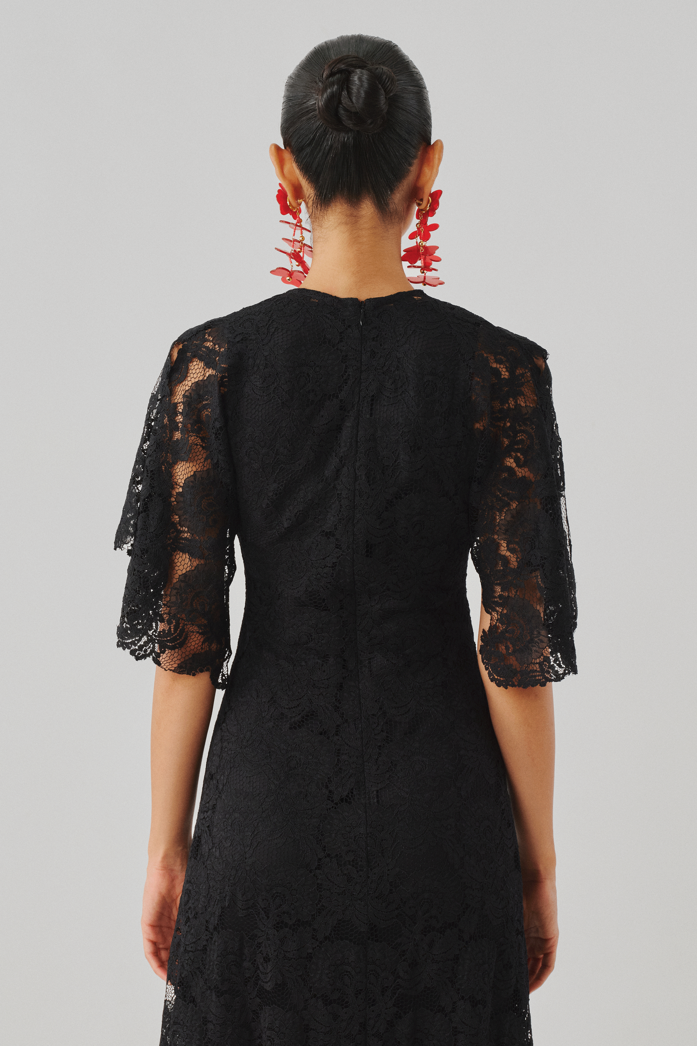Black lace long-sleeve dress with a fitted silhouette, rear view
