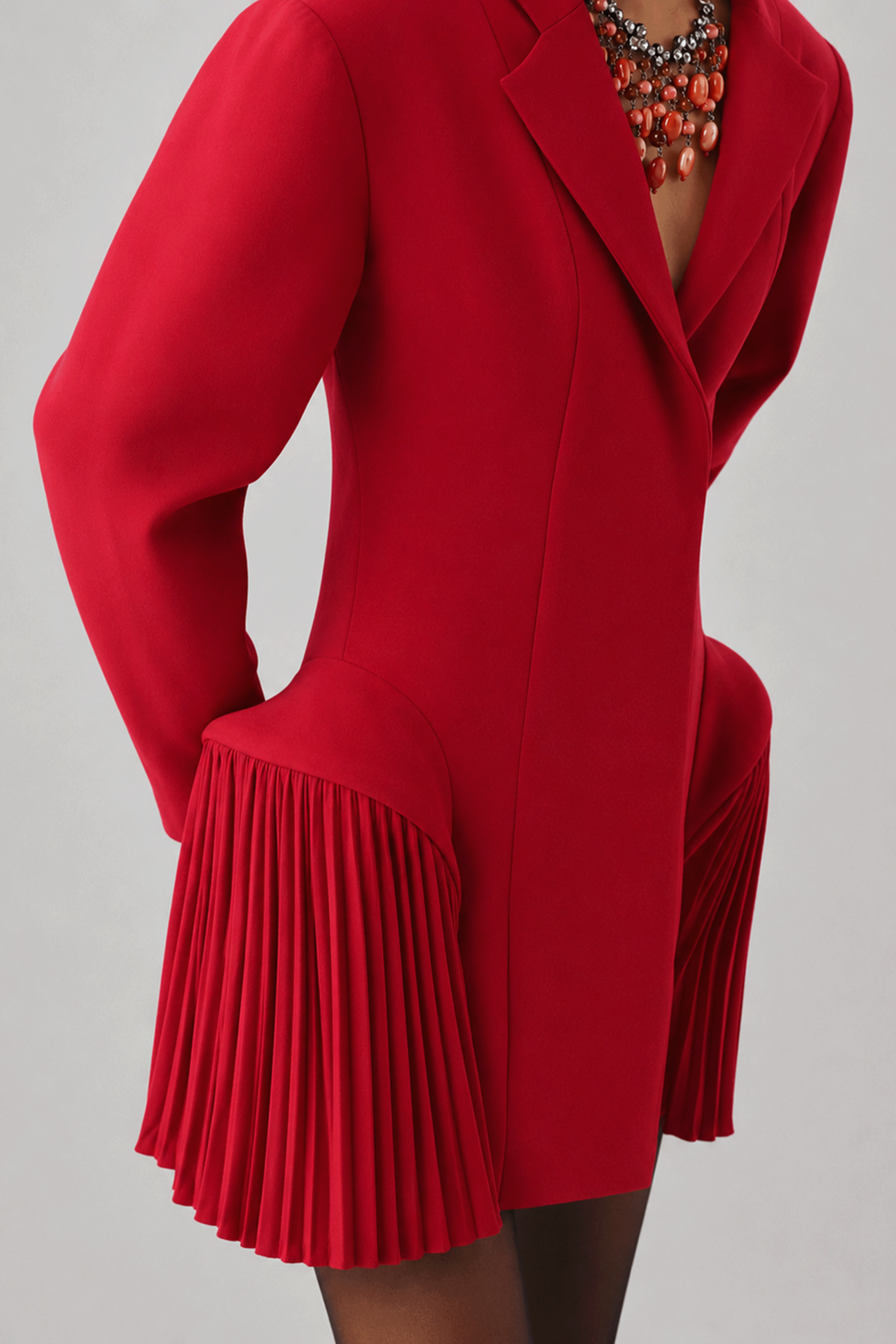 Red mini dress with pleated cuff detail, close-up rear view