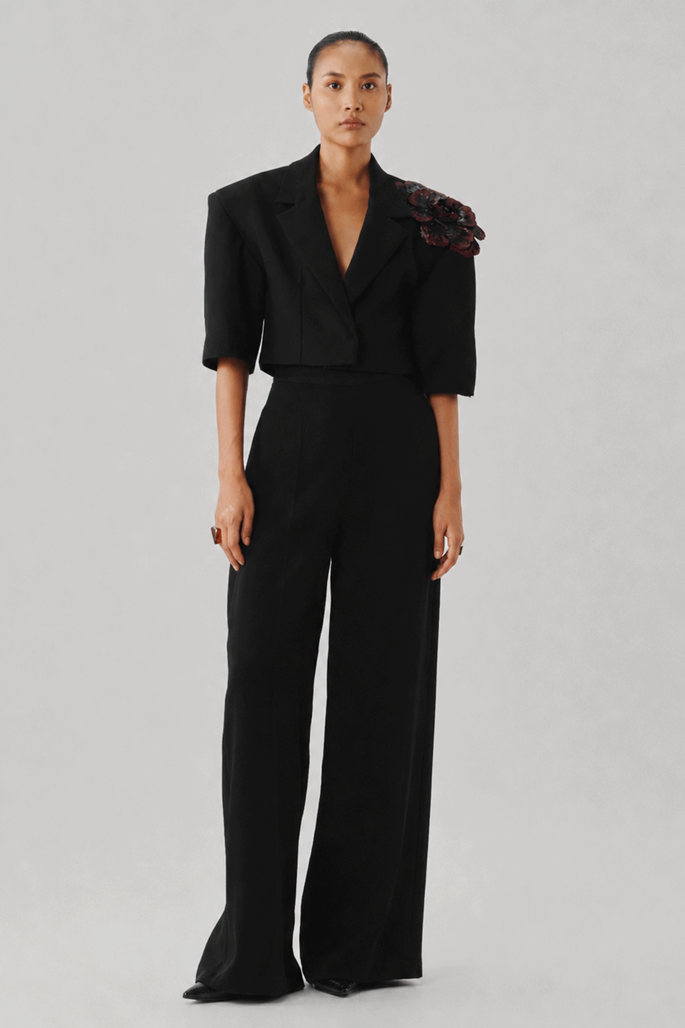 Black tailored jumpsuit with wide legs, full-length front view