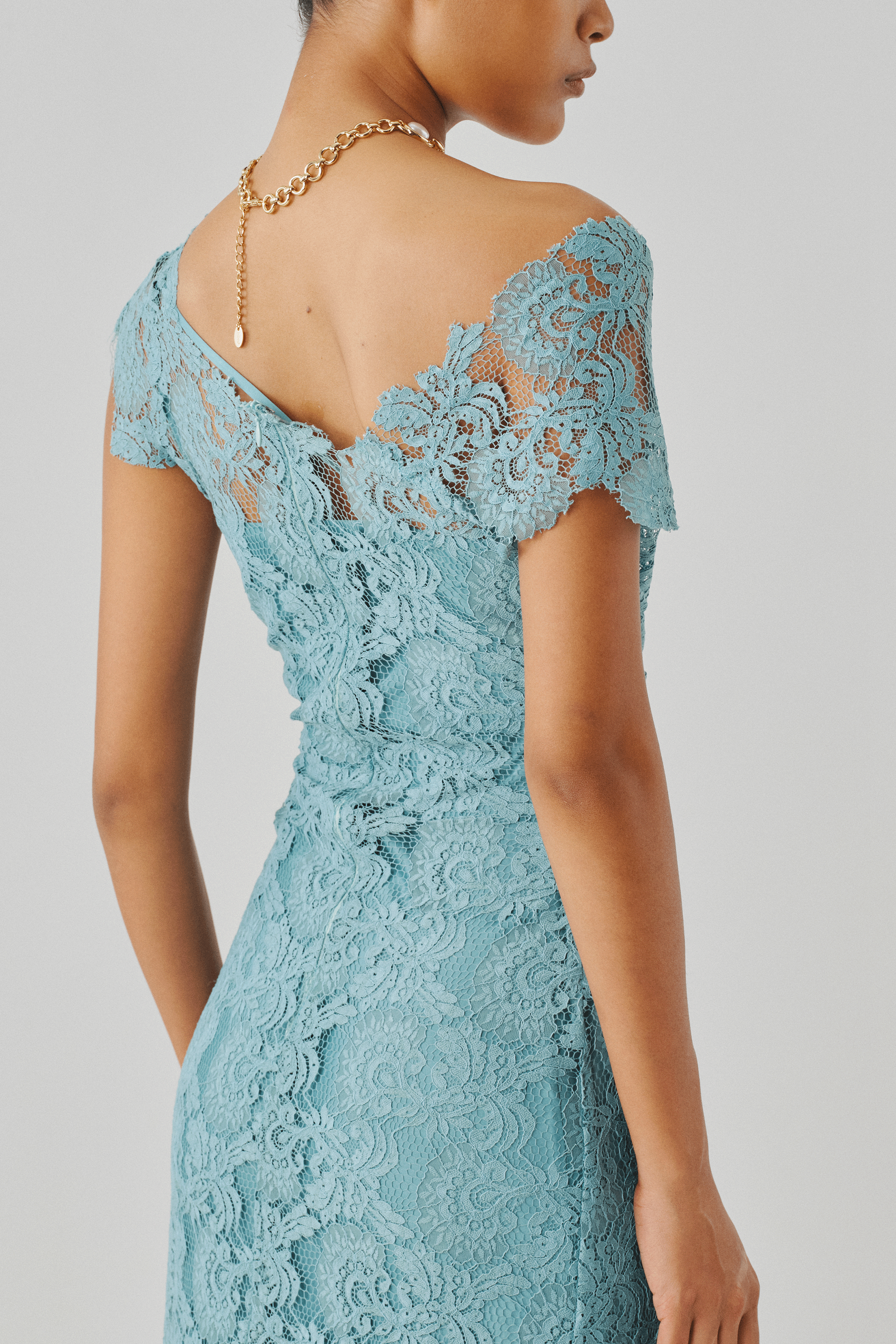 Sky blue lace gown with a scalloped hem, rear view close-up