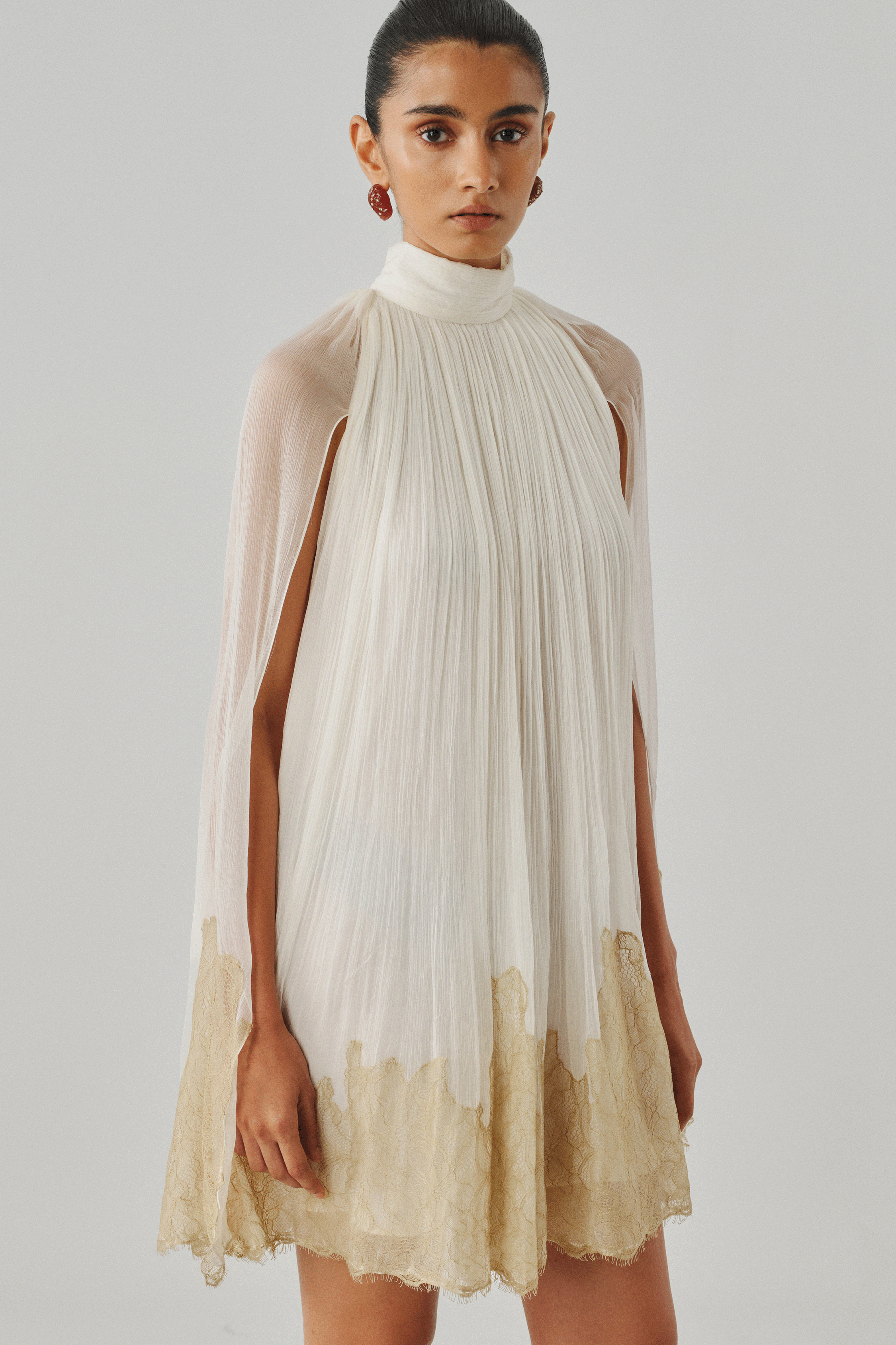 Ivory sheer cape dress with a gold dip-dyed hem, front full view