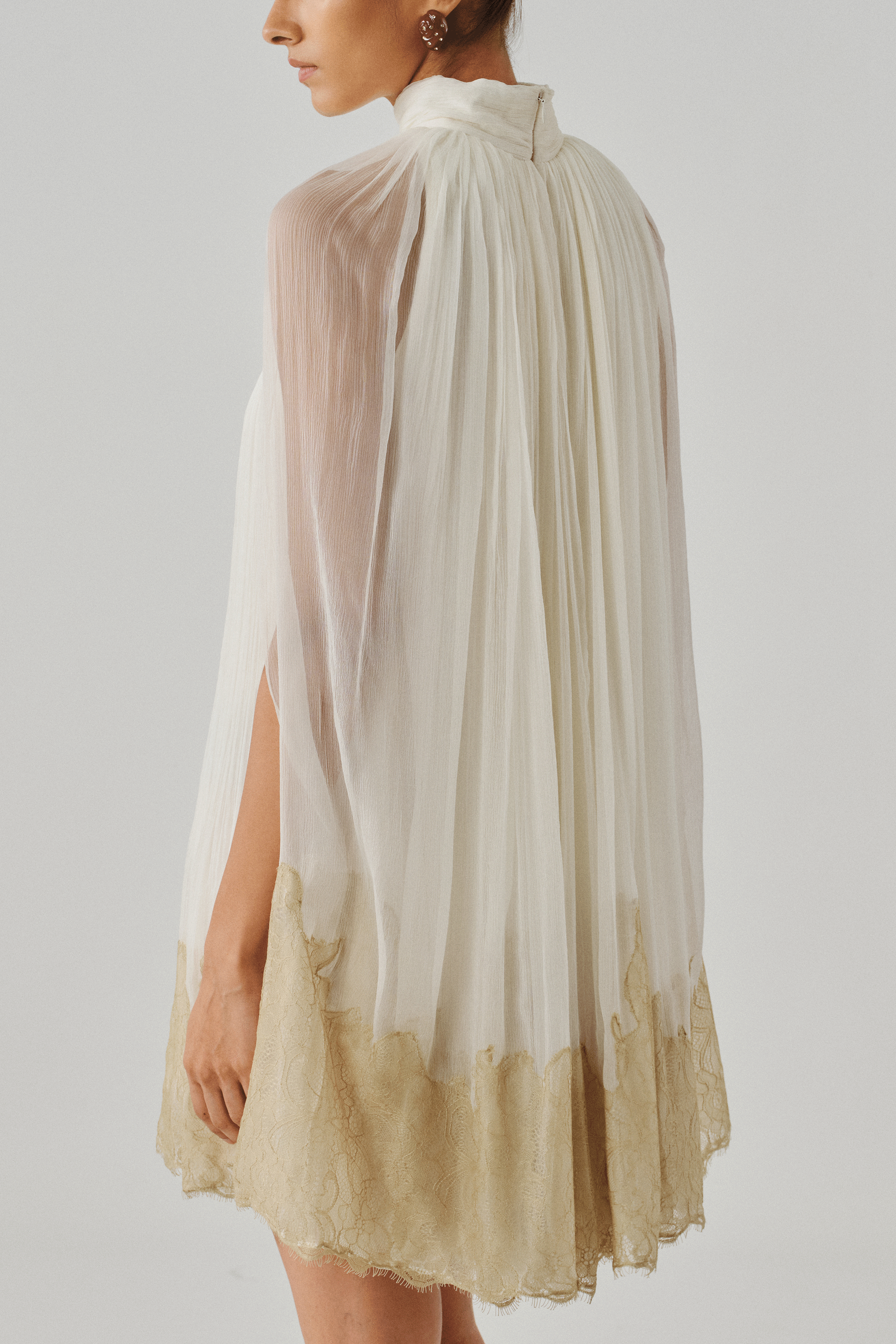 Ivory sheer cape dress with a gold dip-dyed hem, front view