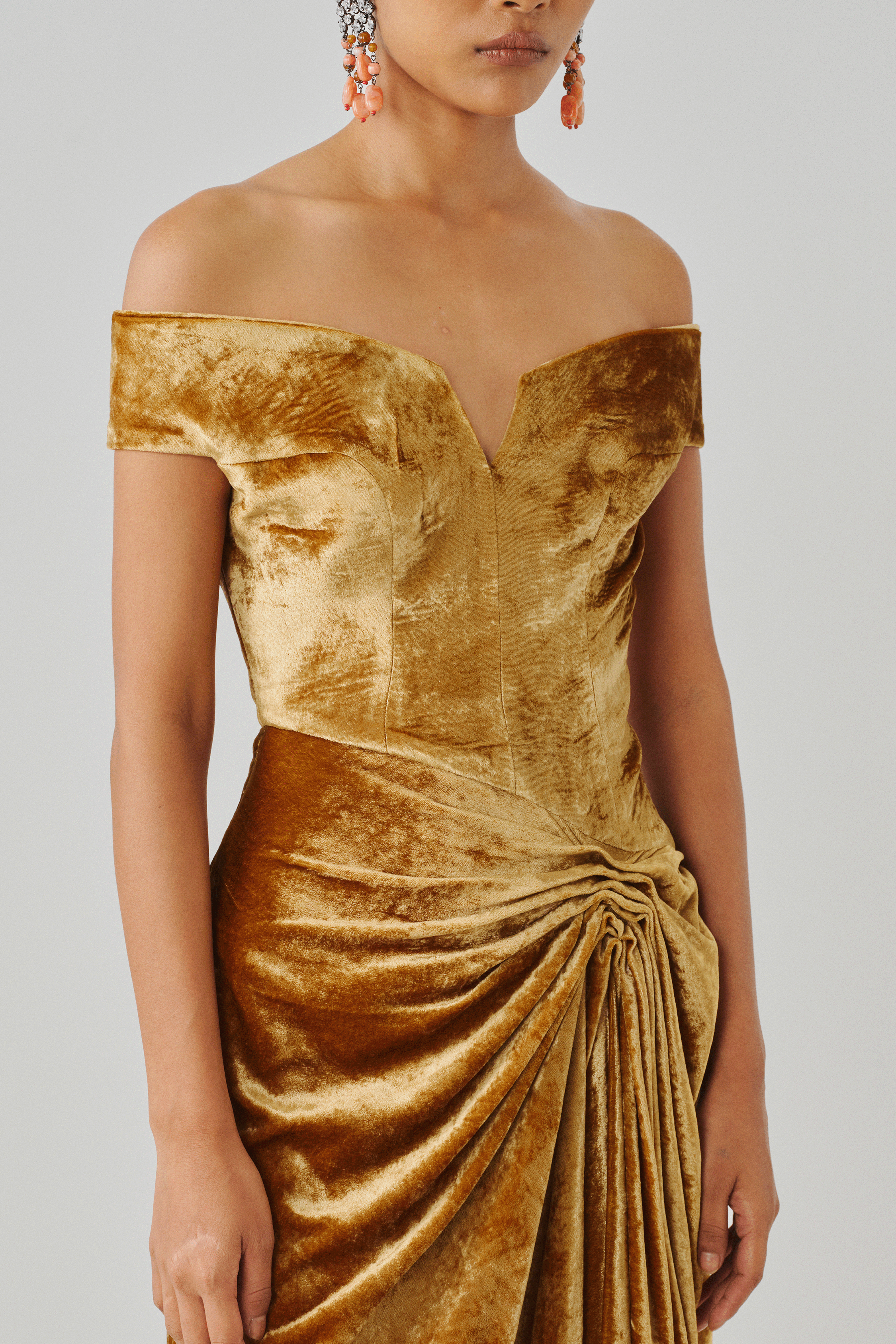 Gold velvet off-shoulder gown with draped waist folds, front view