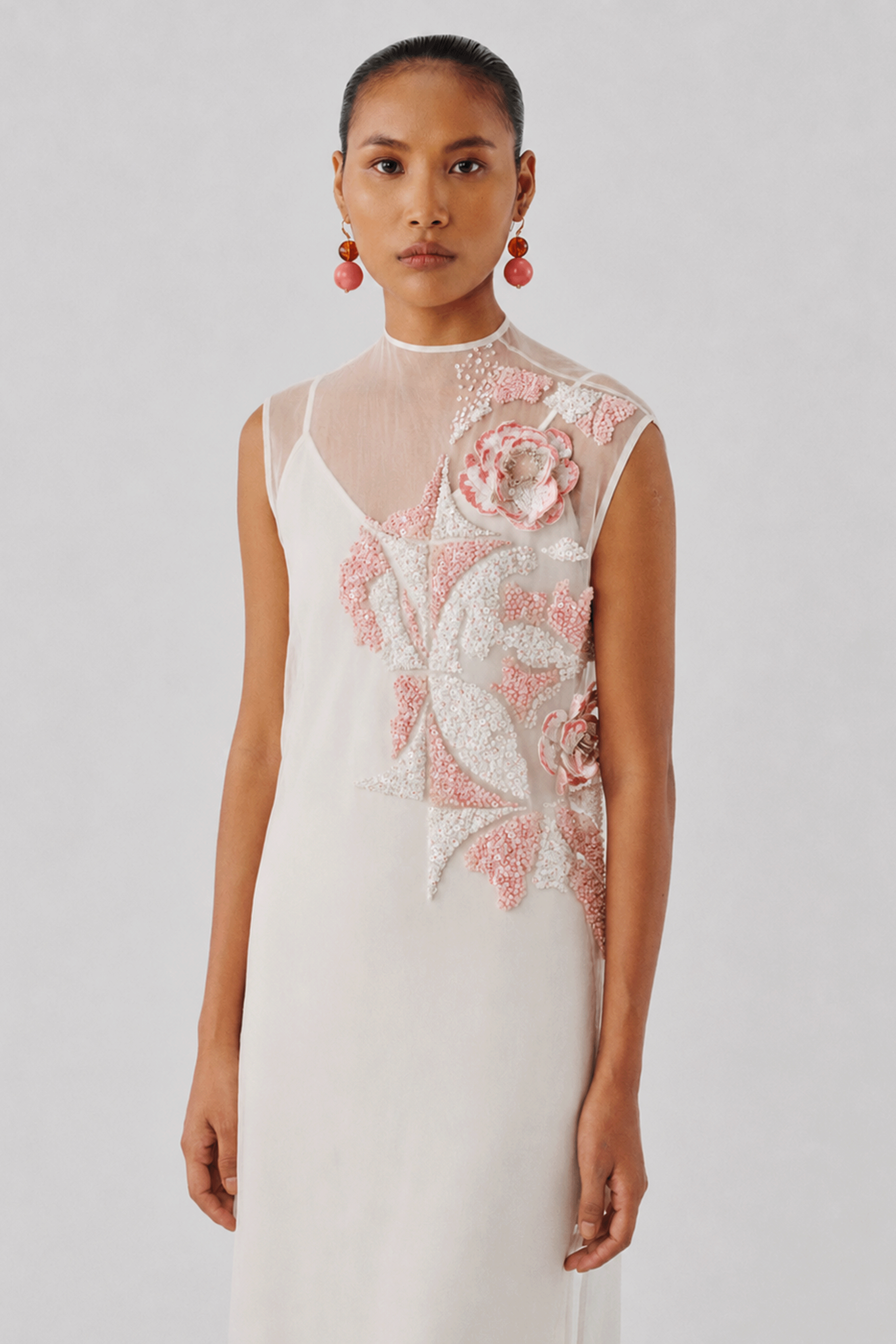 Ivory dress with a hand-embellished floral appliqué, front view