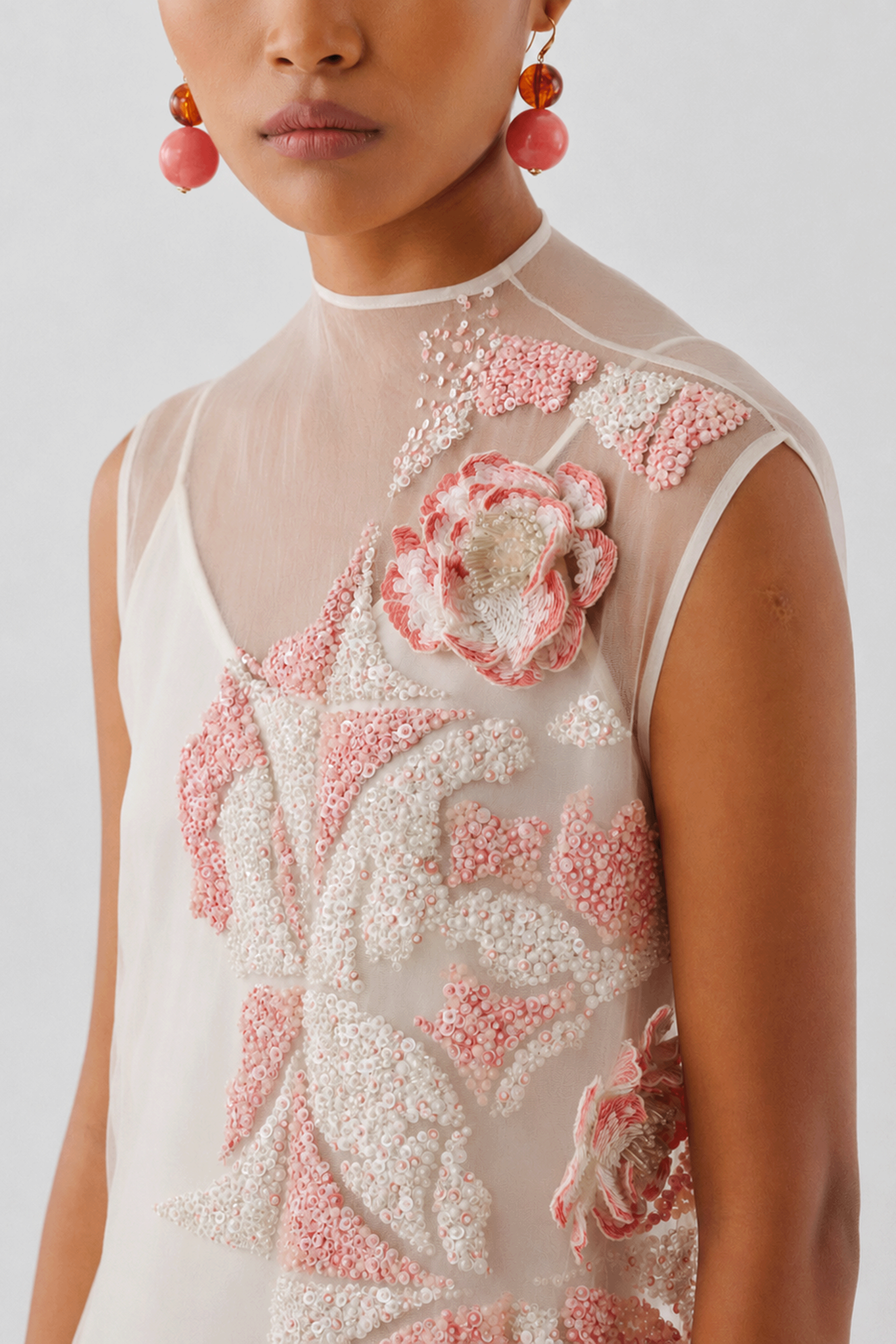 Ivory dress with hand-embellished floral appliqué, close-up front
