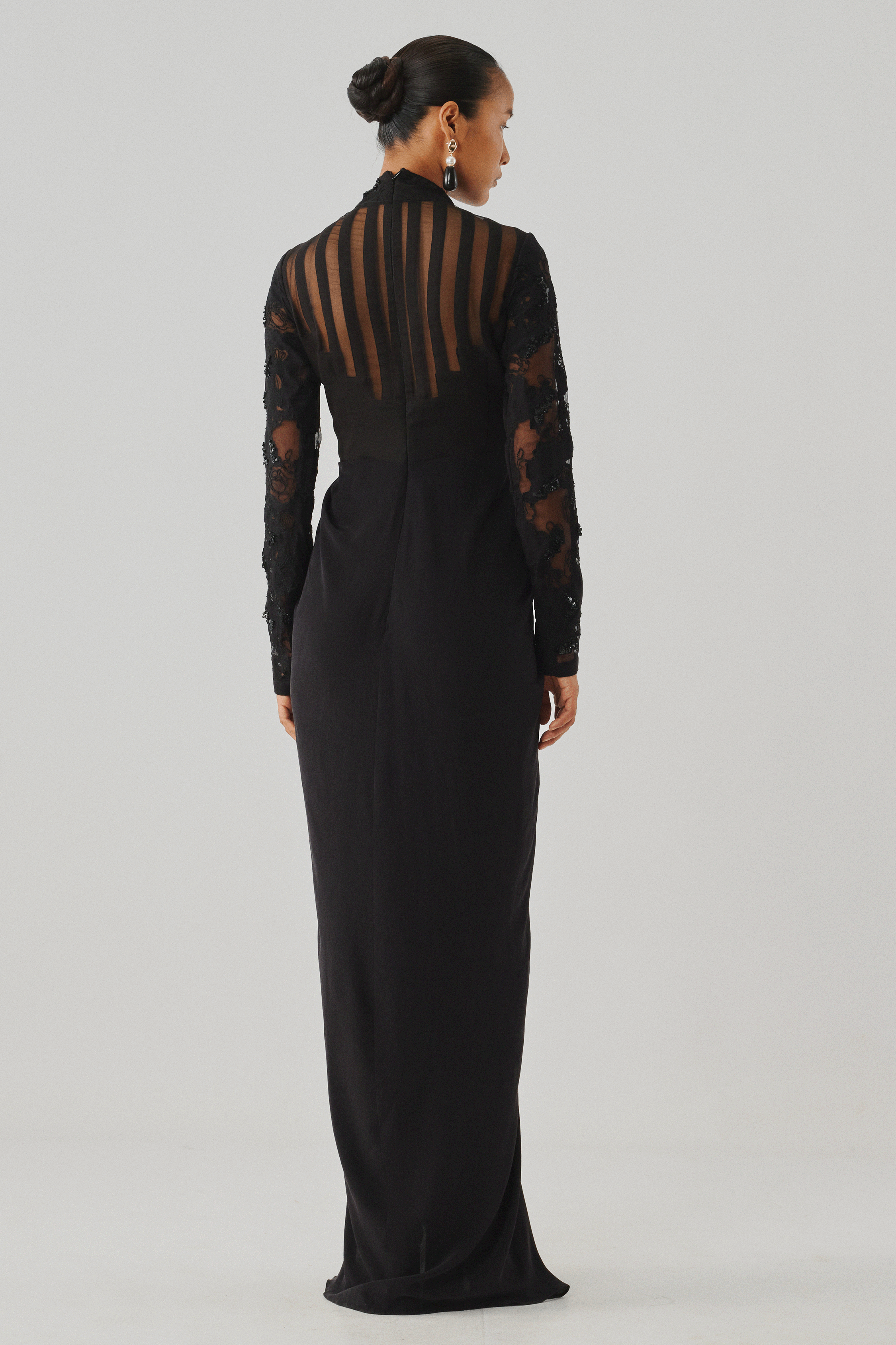 Black long-sleeve lace gown with a high mock neckline, rear view