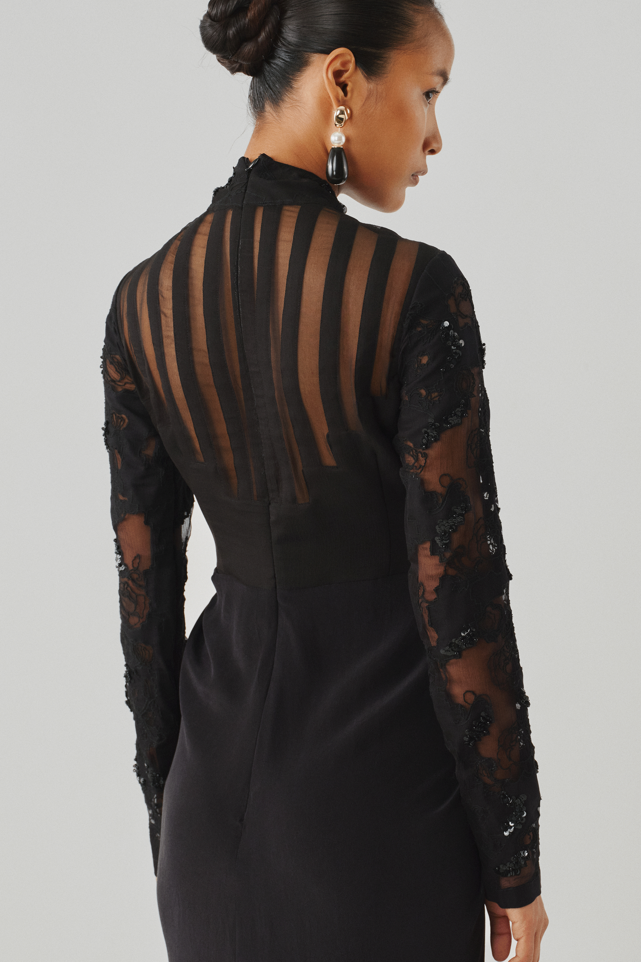 Black sheer lace long-sleeve gown, rear close-up detail view