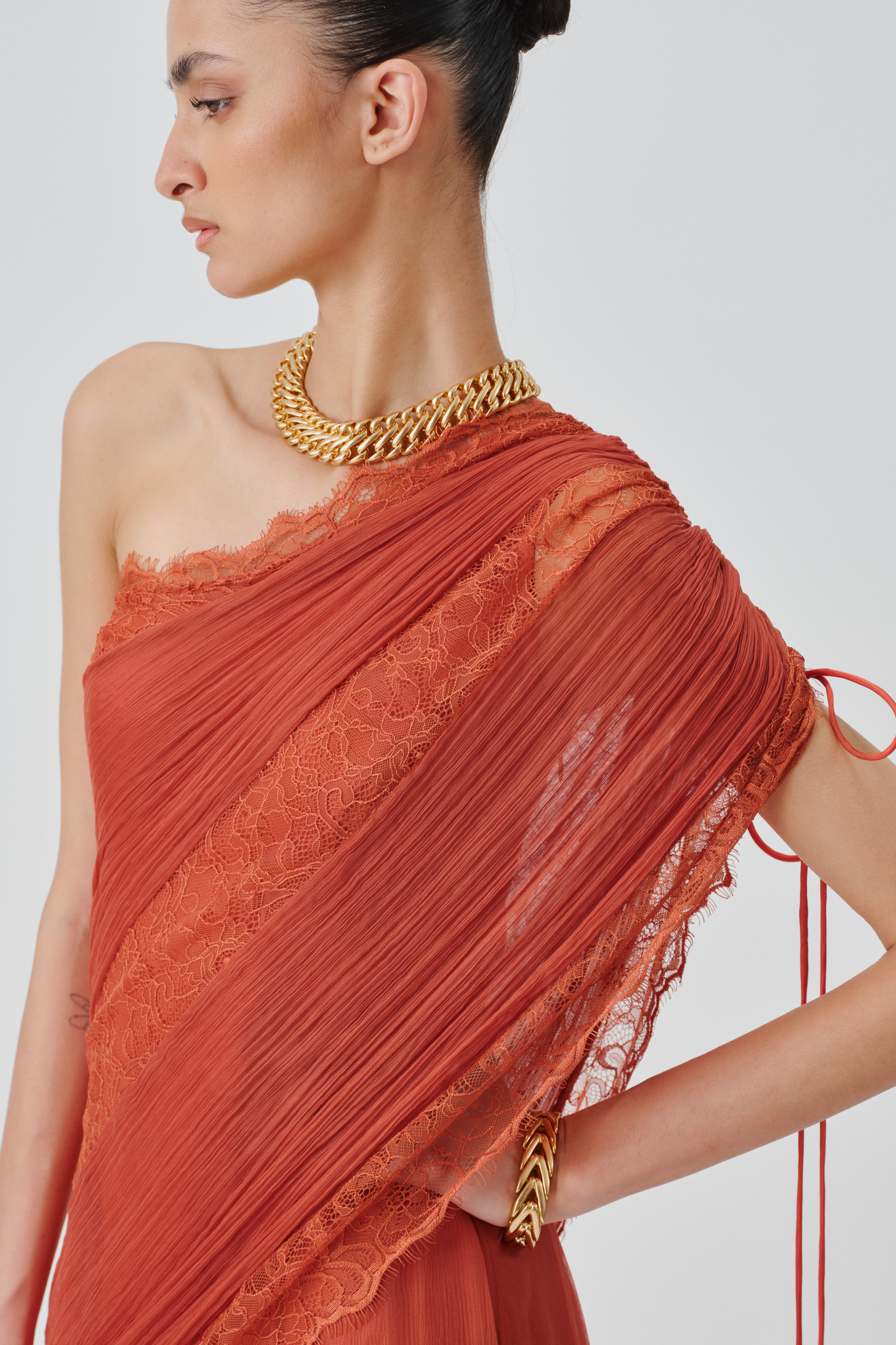 Model posing to showcase neckline view of ira dress